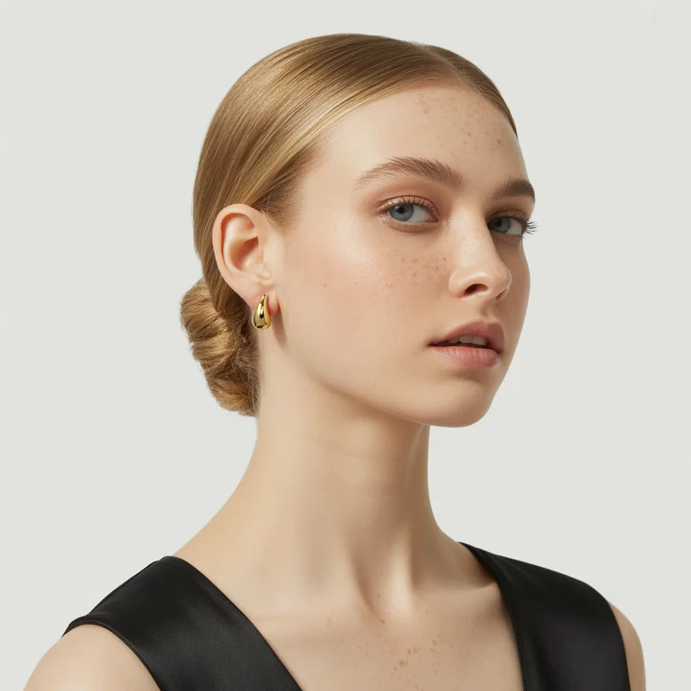 Model wearing the 18k gold Aella Teardrop Stud Earrings for a minimalist look.
