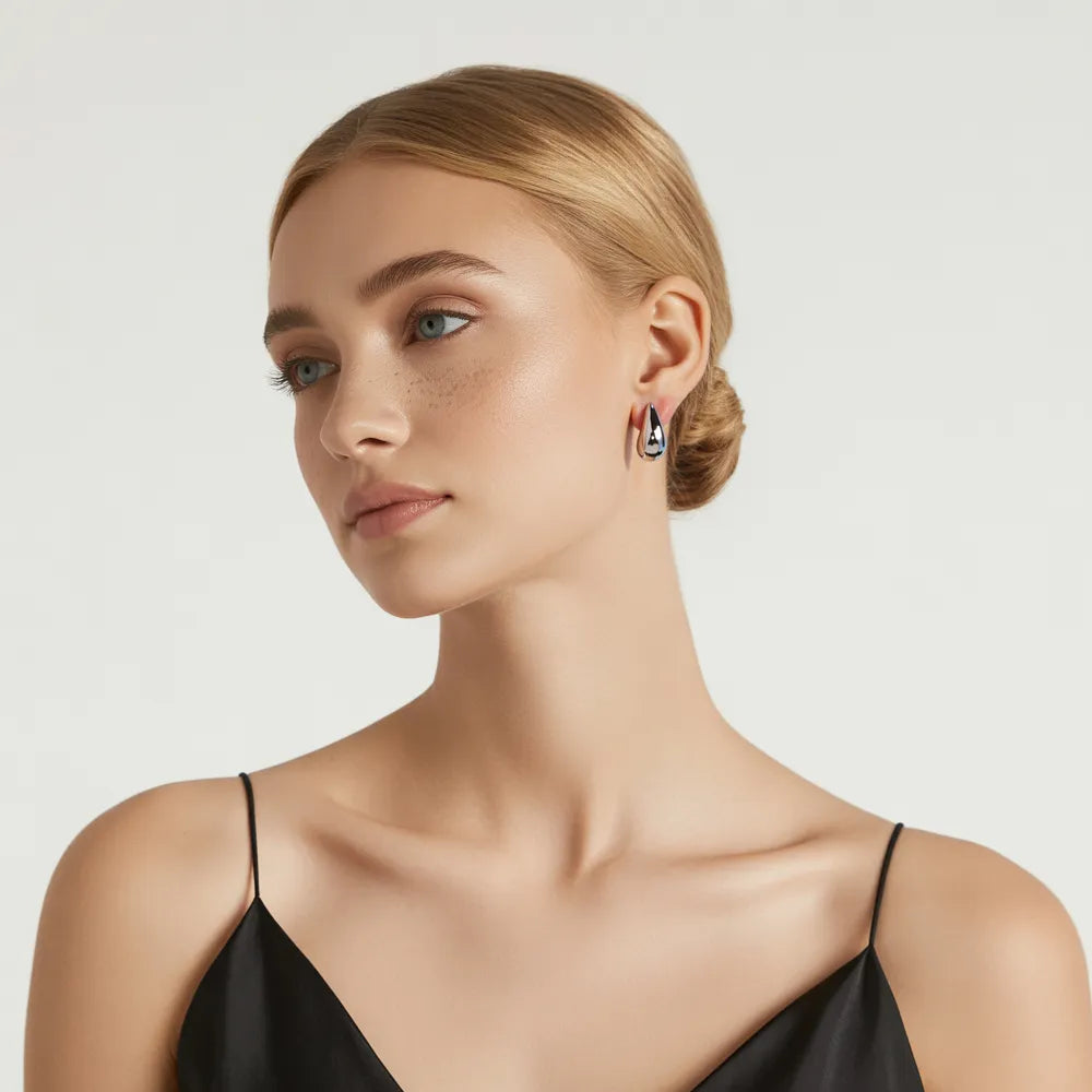 Model wearing the polished 316L stainless steel Aella Teardrop Stud Earrings