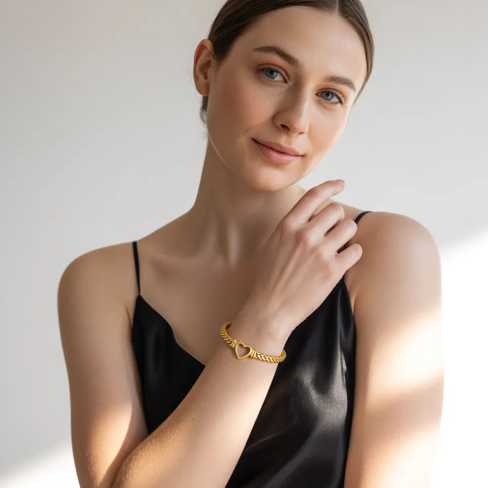 A model wearing the bold 18k gold plated Harlow Chunky Heart Bracelet to showcase its hip-hop inspired style