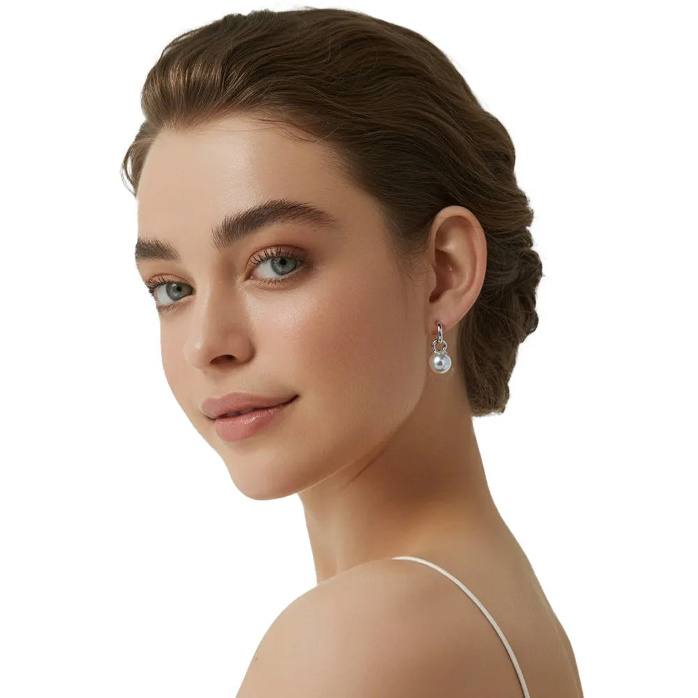 Woman showcasing the sophisticated vintage pearl dangle earrings.