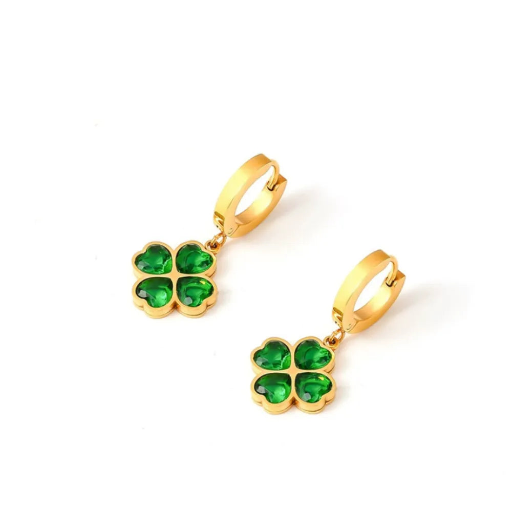 Pair of 18k gold hoop earrings with dangling emerald green clover charms.