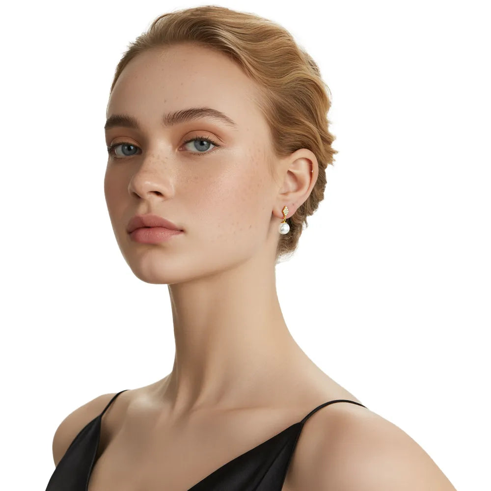 Model wearing the 18k gold plated Elara Pavé Kite & Pearl Drop Earrings.