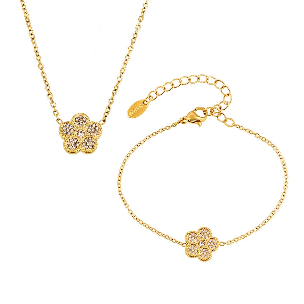 The Flora Pavé Flower Jewelry Set in 18k gold, including the necklace and bracelet.