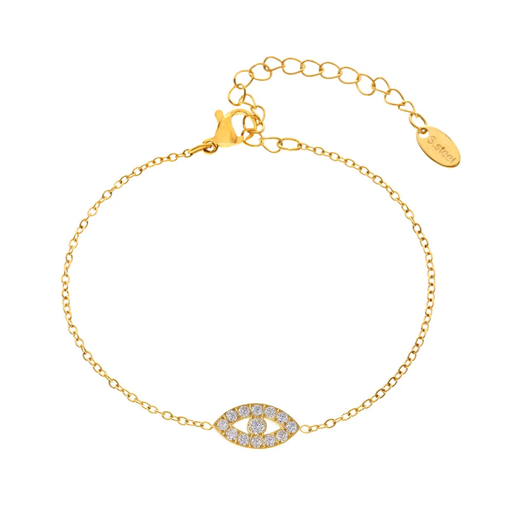 18k gold dainty chain bracelet with a sparkling pavé evil eye charm on a white background