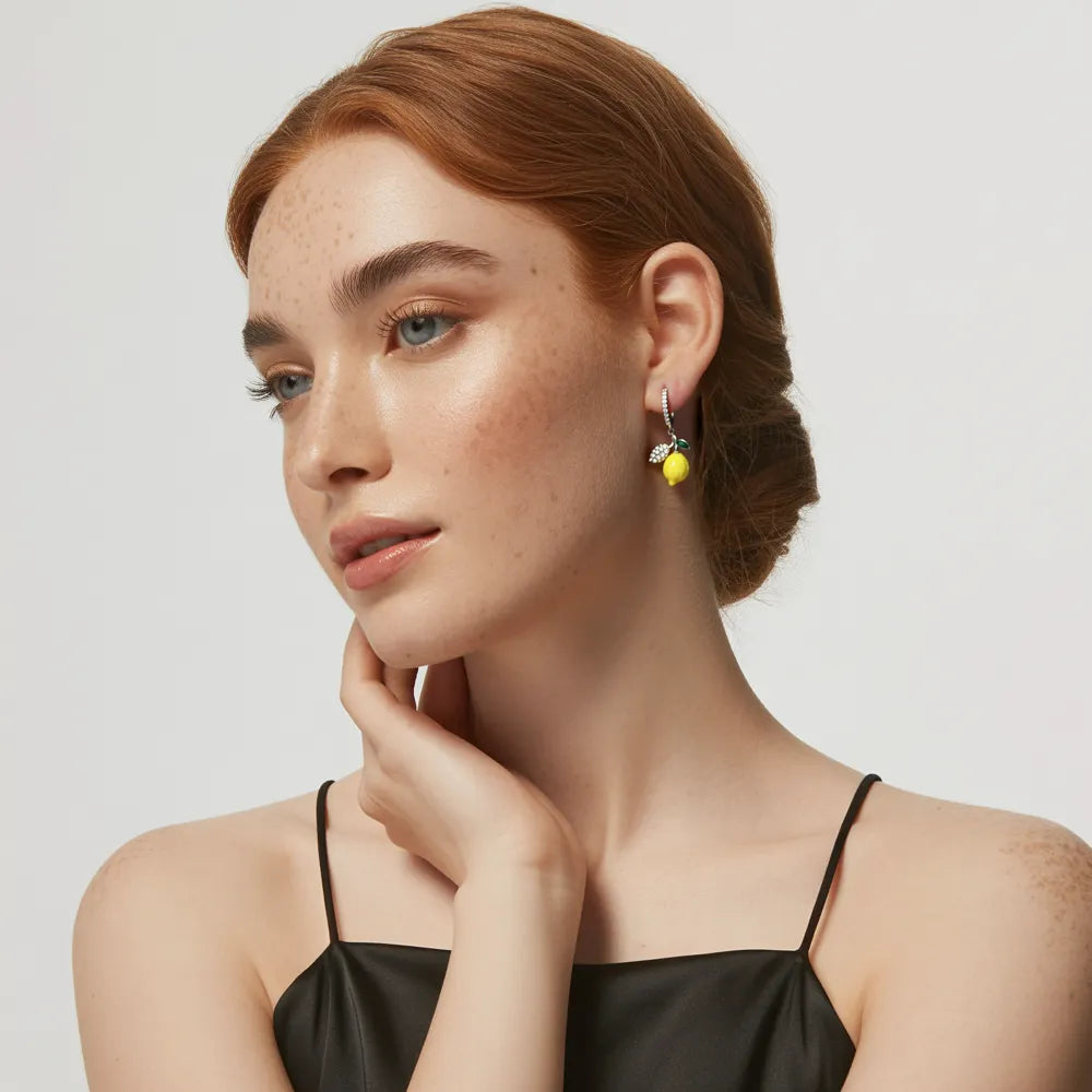 Model showcasing the 316L stainless steel Lemon Zest Huggie Hoops, highlighting their playful charm.