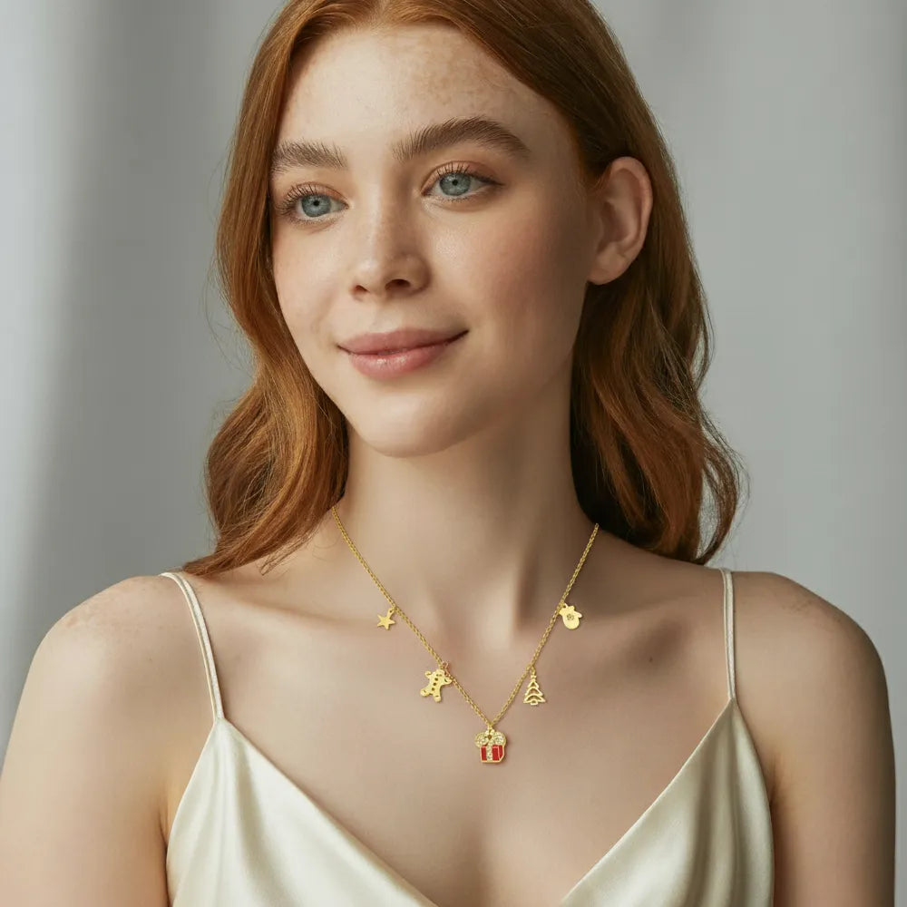 A close-up view of the three colorful enamel charms on the Festive Necklace as worn by a model