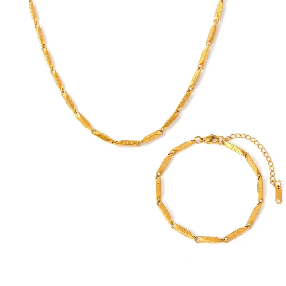 18k gold plated necklace and bracelet set featuring engraved geometric links on a white background