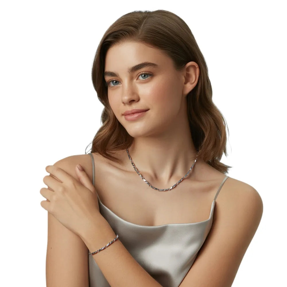 Woman showcasing the sleek, modern style of the silver-tone engraved link jewelry set