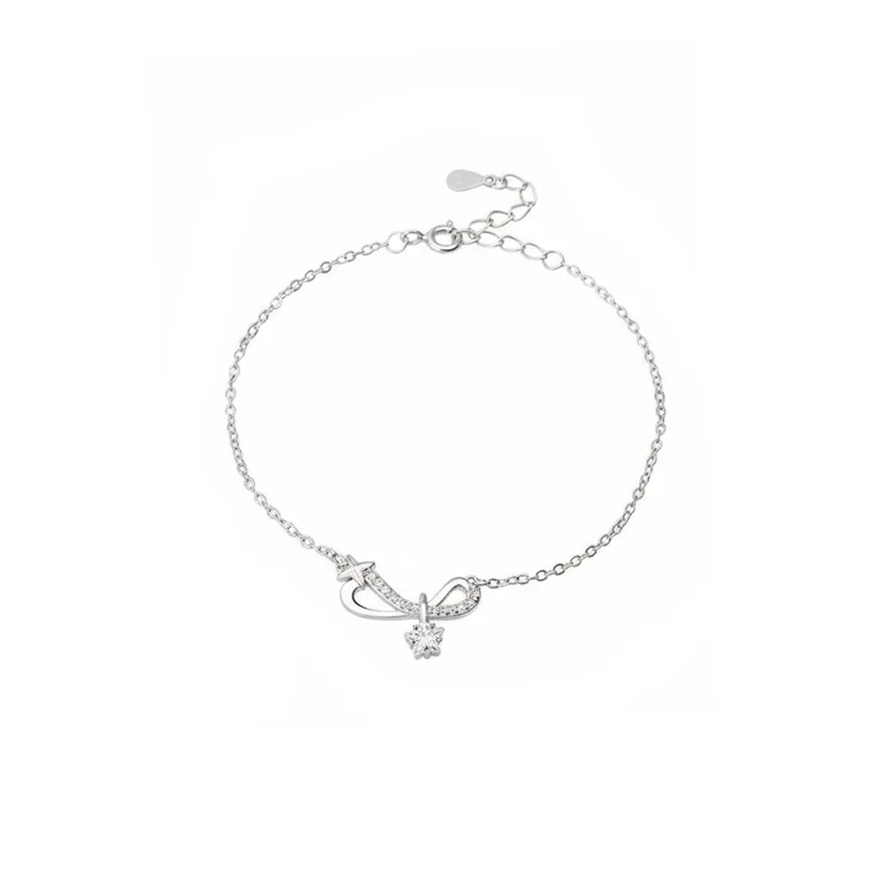 S925 sterling silver pavé infinity bow bracelet with a solitaire star charm on a white background