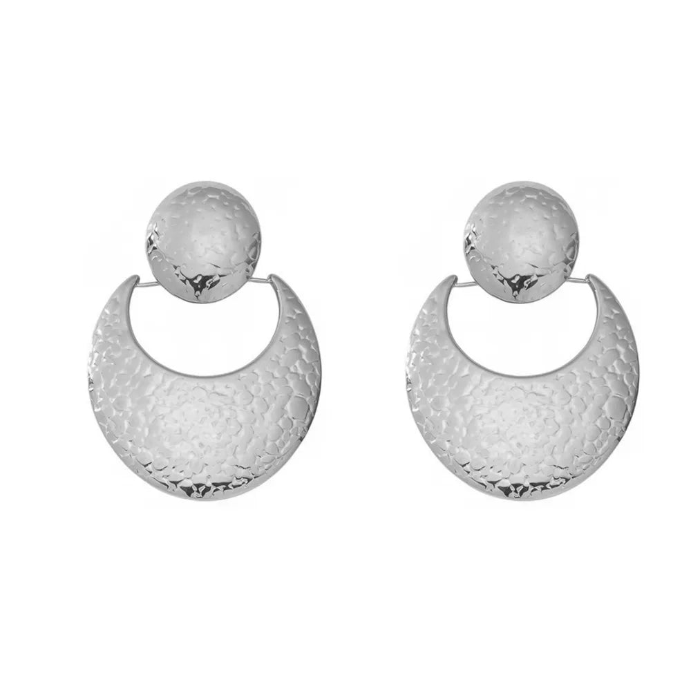Silver 316L stainless steel drop earrings with a handcrafted hammered finish in a sun and crescent moon shape. Waterproof jewelry