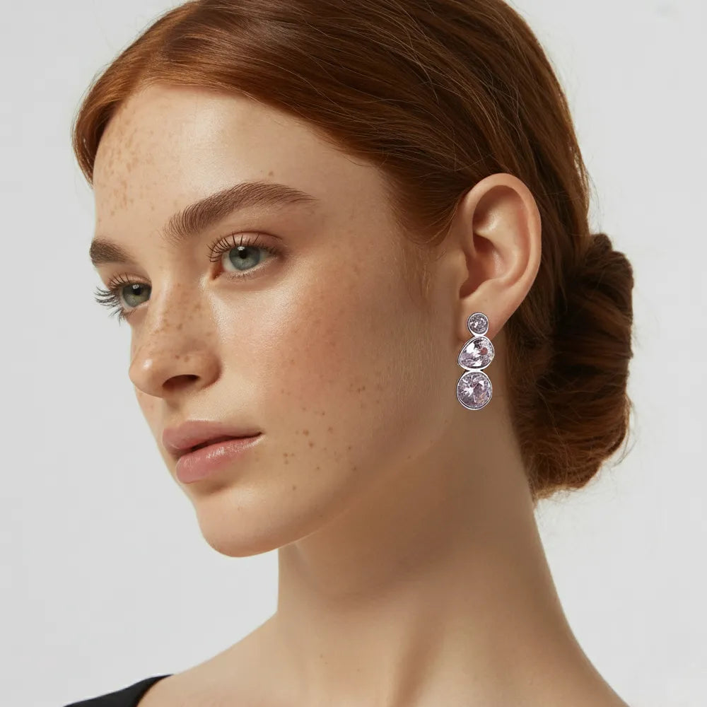 Full shot of a model wearing the brilliant silver Aura Trio-Stone Stud Earrings.