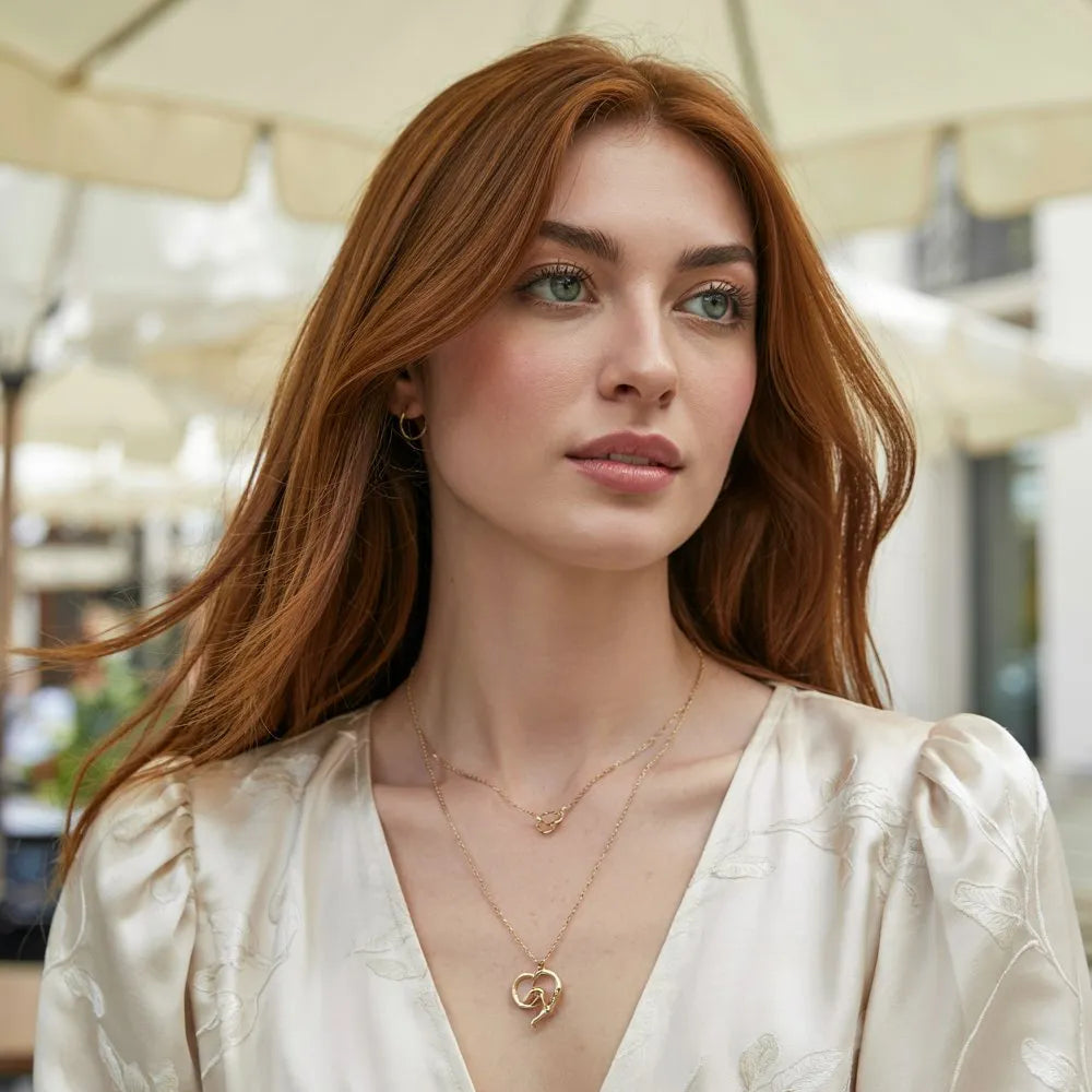 A woman smiling and wearing an everyday stainless steel jewelry necklace that is waterproof and tarnish-resistant