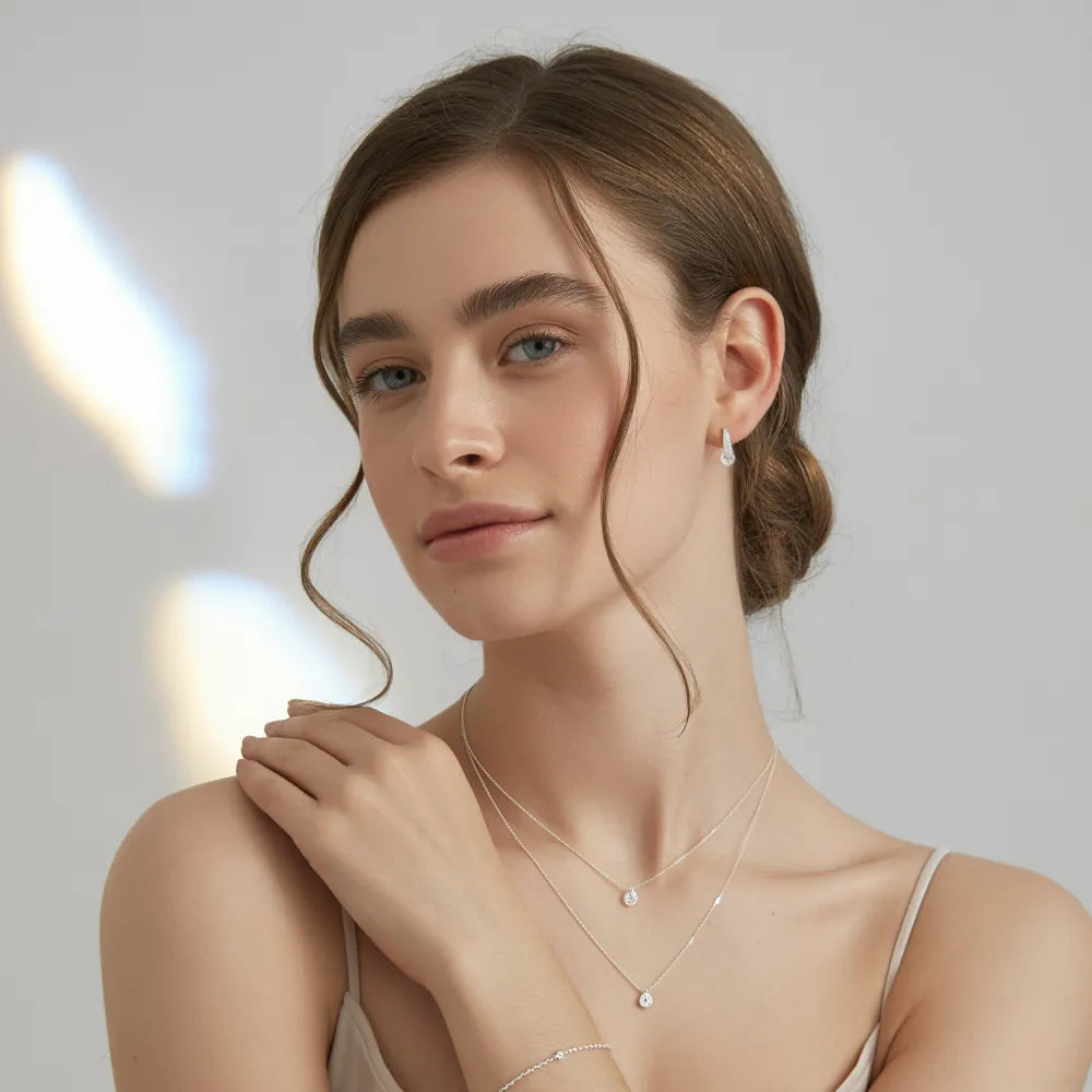 A model wearing a layered 925 sterling silver necklace and rings from the GlamBodyCandy silver jewelry collection for women.