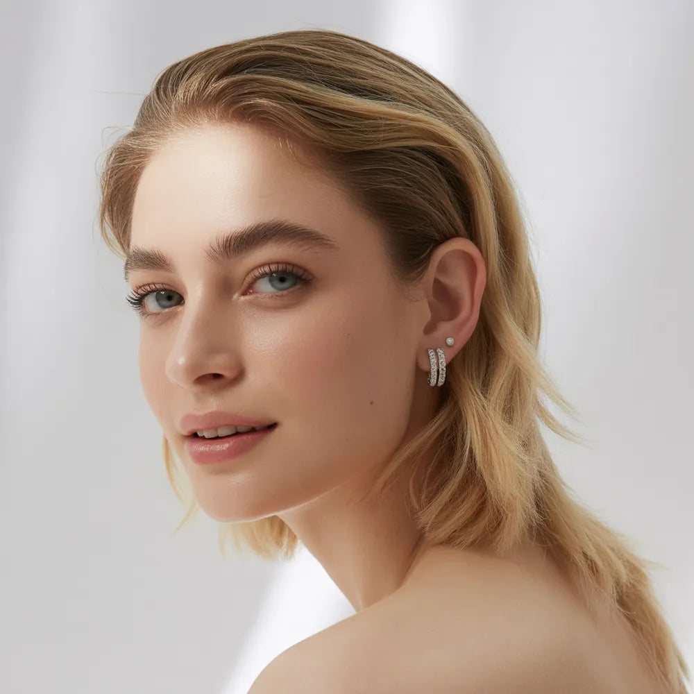 A model wearing a pair of dainty hypoallergenic stainless steel earrings for women by GlamBodyCandy