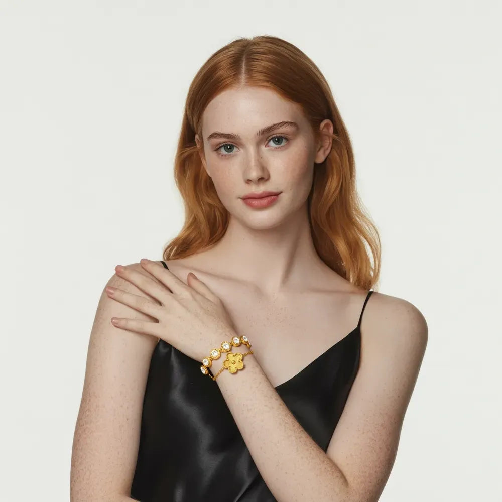 A model's wrist adorned with a gold bracelet stack, showcasing the perfect female gold bracelet from the GlamBodyCandy gold bracelets collection