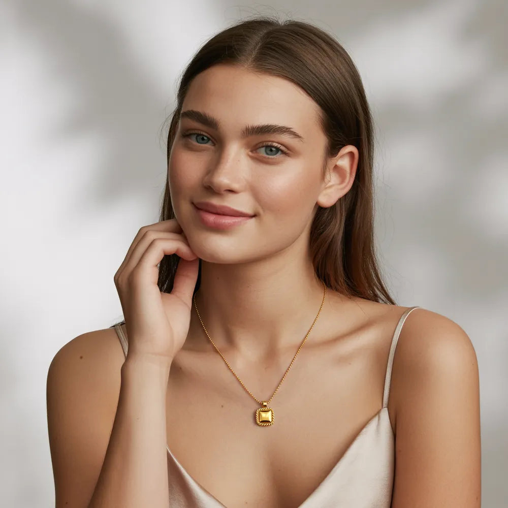 A model wearing a layered stack of gold necklaces, including a classic gold pendant necklace, from the GlamBodyCandy gold necklace for women collection