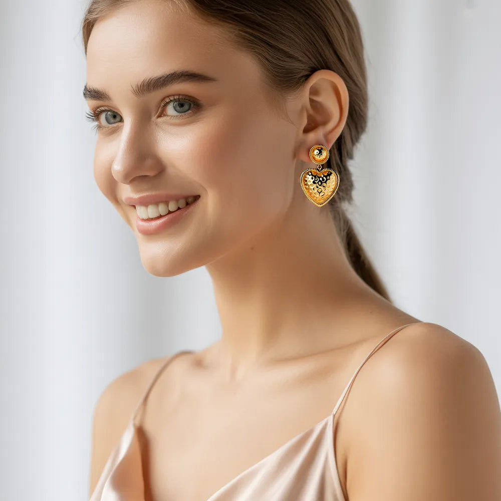 A model showcasing gold plated earrings, including elegant dangle styles and classic hoop gold earrings for women, from GlamBodyCandy