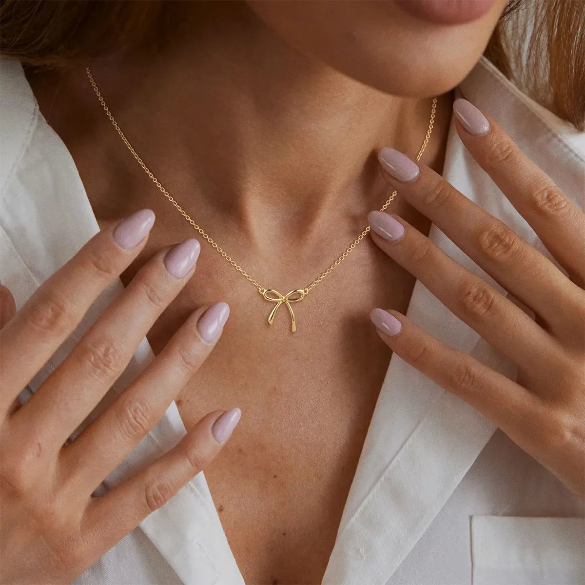 Model wearing 18K PVD gold-plated necklace, fine jewelry