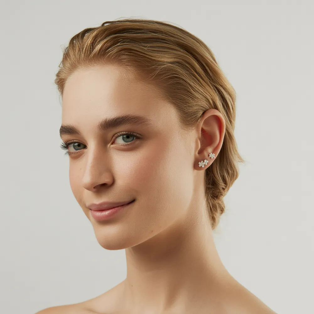 A close-up of a model's ear, wearing a pair of hypoallergenic stainless steel stud earrings for women by GlamBodyCandy.