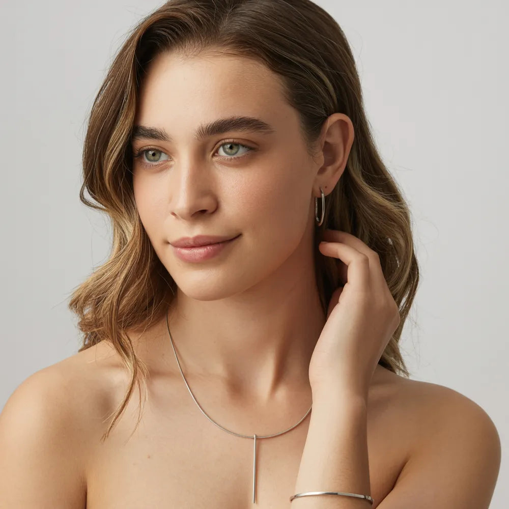 A collection of waterproof stainless steel jewelry, including necklaces and rings, by GlamBodyCandy