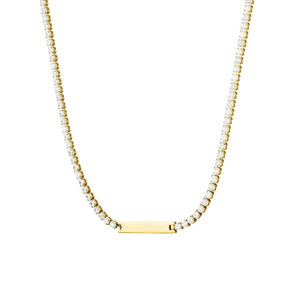 Studio shot of an 18K gold plated stainless steel necklace featuring a crystal tennis chain with a polished rectangular bar pendant, isolated on white.