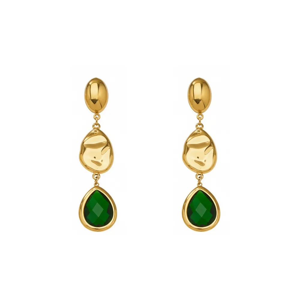 Studio shot of 18K gold plated drop earrings featuring a faceted emerald green glass teardrop stone and textured gold accents, isolated on white