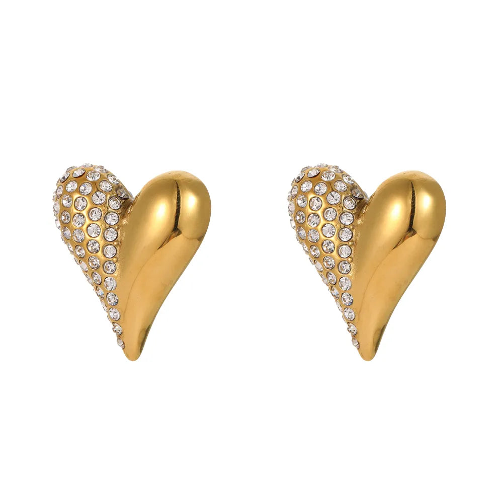 Close-up of 18K gold plated heart stud earrings featuring a half-polished and half-pave cubic zirconia design isolated on white.