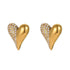 Close-up of 18K gold plated heart stud earrings featuring a half-polished and half-pave cubic zirconia design isolated on white.