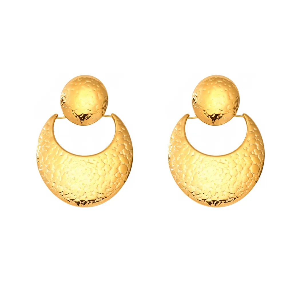 Studio shot of 18K gold plated stainless steel drop earrings featuring a hammered texture sun disc and crescent moon design, isolated on white