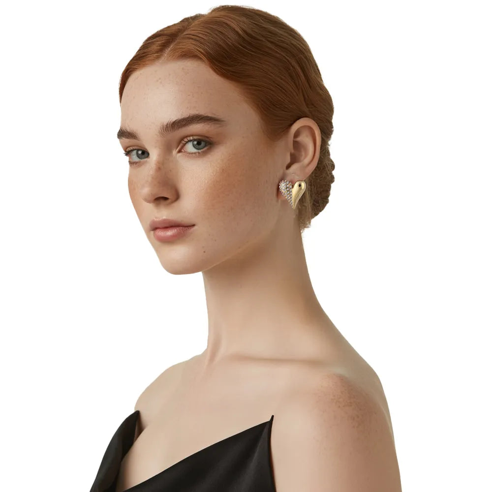 Close-up view of a model wearing the 18K gold pave heart stud earrings, highlighting the dual-texture shine on the earlobe.