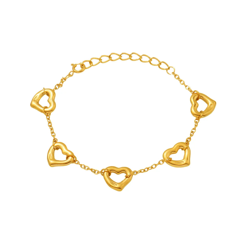 Studio shot of an 18K gold plated chain bracelet featuring five evenly spaced hollow heart charms, isolated on white.