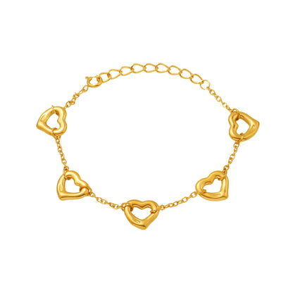 Studio shot of an 18K gold plated chain bracelet featuring five evenly spaced hollow heart charms, isolated on white.