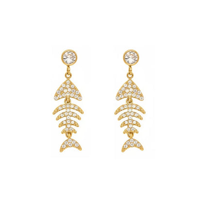 Studio shot of 18K gold plated articulated fish bone earrings paved with sparkling cubic zirconia, isolated on white.