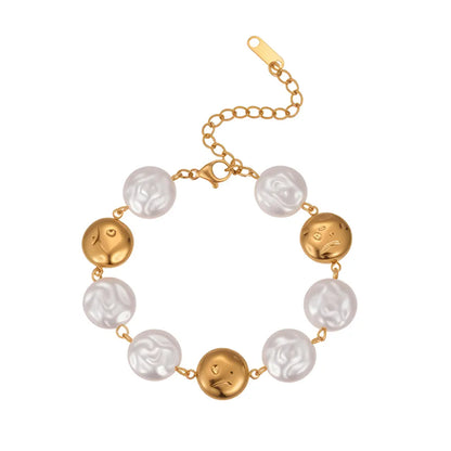 Full view of the 18K gold plated bracelet showing alternating baroque pearls and abstract metal face charms isolated on white