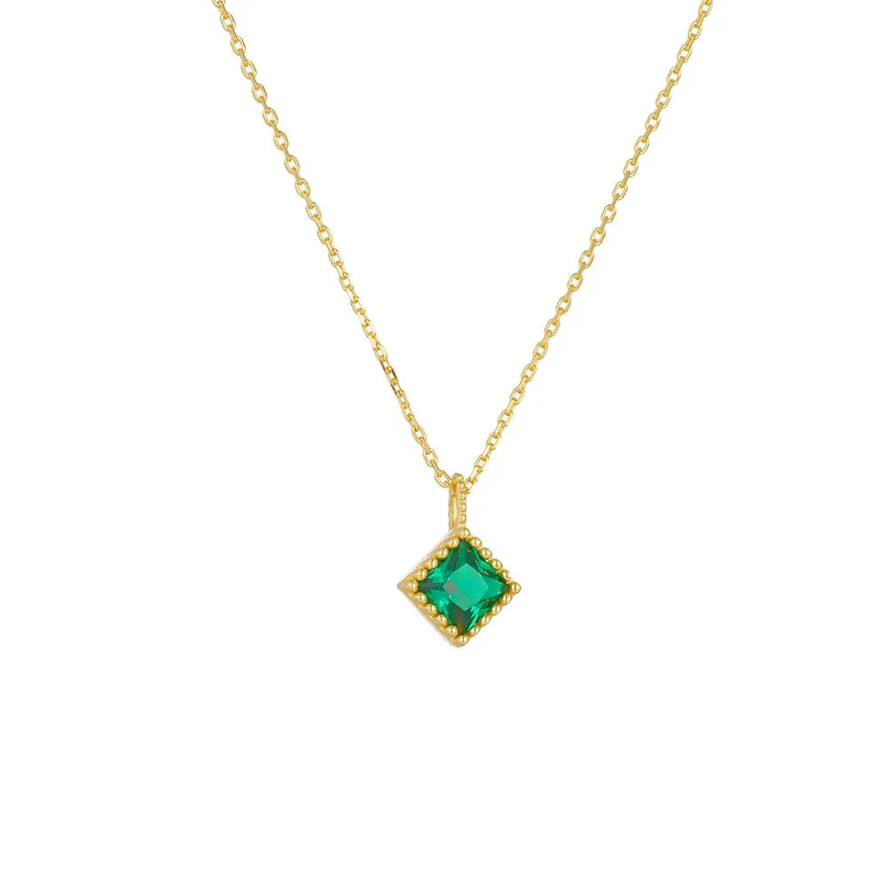 Front view of 18K gold plated S925 silver necklace featuring an emerald green zircon in a beaded rhombus setting on a white background.