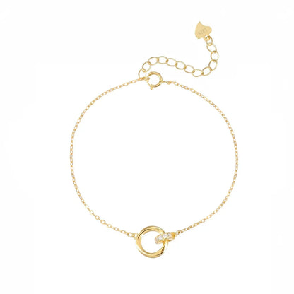 Studio shot of an 18K gold plated S925 sterling silver bracelet featuring interlocking Mobius rings with pave-set crystals, isolated on white