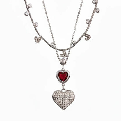 A 2-piece layered necklace set in silver, featuring a choker chain and a pendant chain with two hearts.