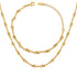 A flat lay of the complete Alia Interlocking Necklace and Bracelet Set in gold.