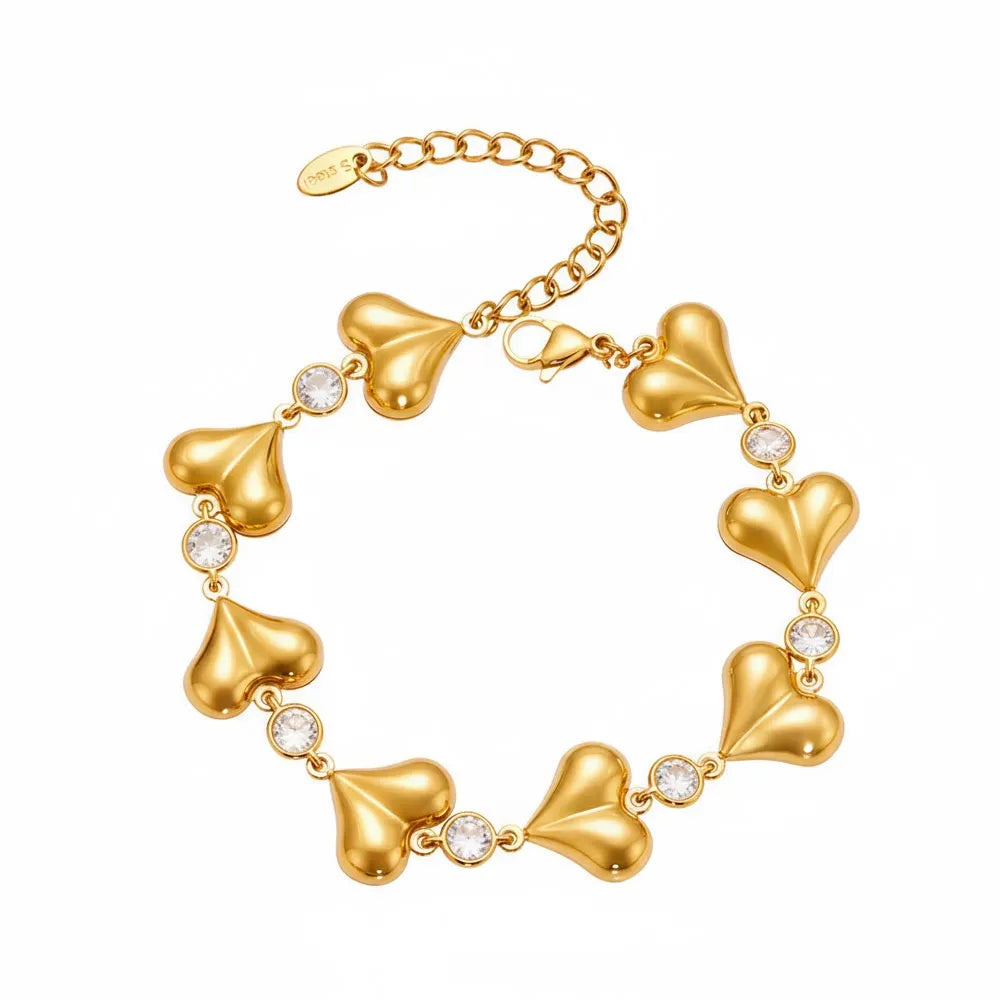 The Amour Heart Charm Bracelet in 18k gold plate, featuring a chunky link chain and polished heart charm, on a white background.