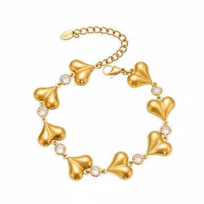 The Amour Heart Charm Bracelet in 18k gold plate, featuring a chunky link chain and polished heart charm, on a white background.