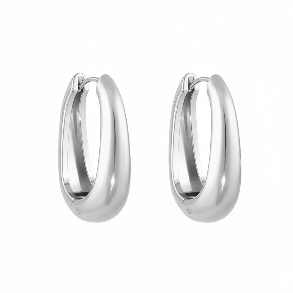 Pair of Anya Sculptural Hoop Earrings in polished 316L stainless steel.

