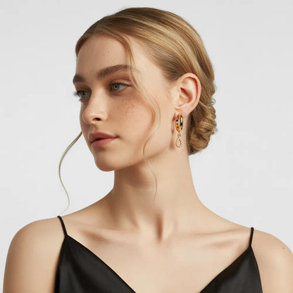 Woman with blonde hair showcasing the elegant dangle of the 18k gold teardrop earrings.