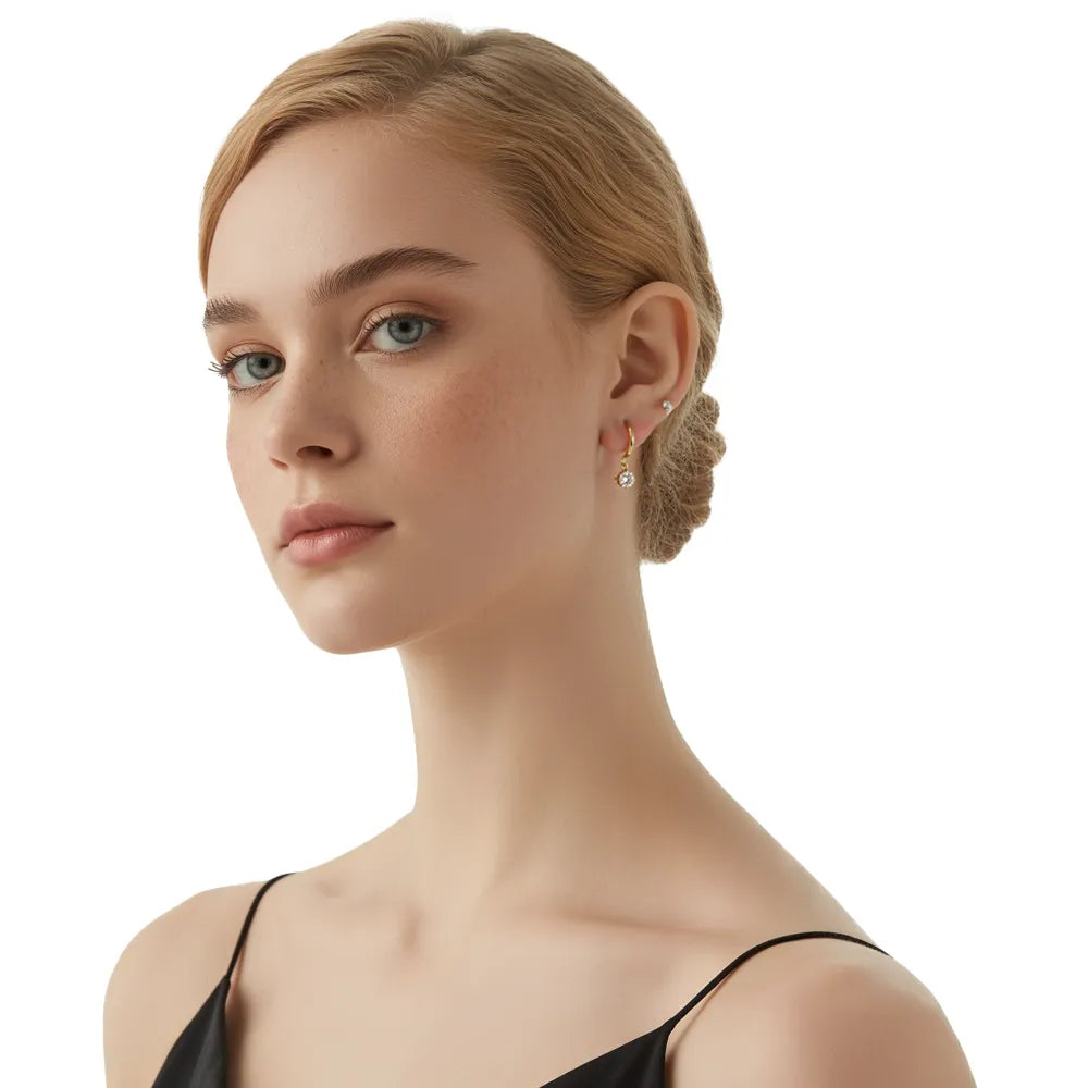 Model wearing the 18k gold Astra Solitaire Dangle Earrings.