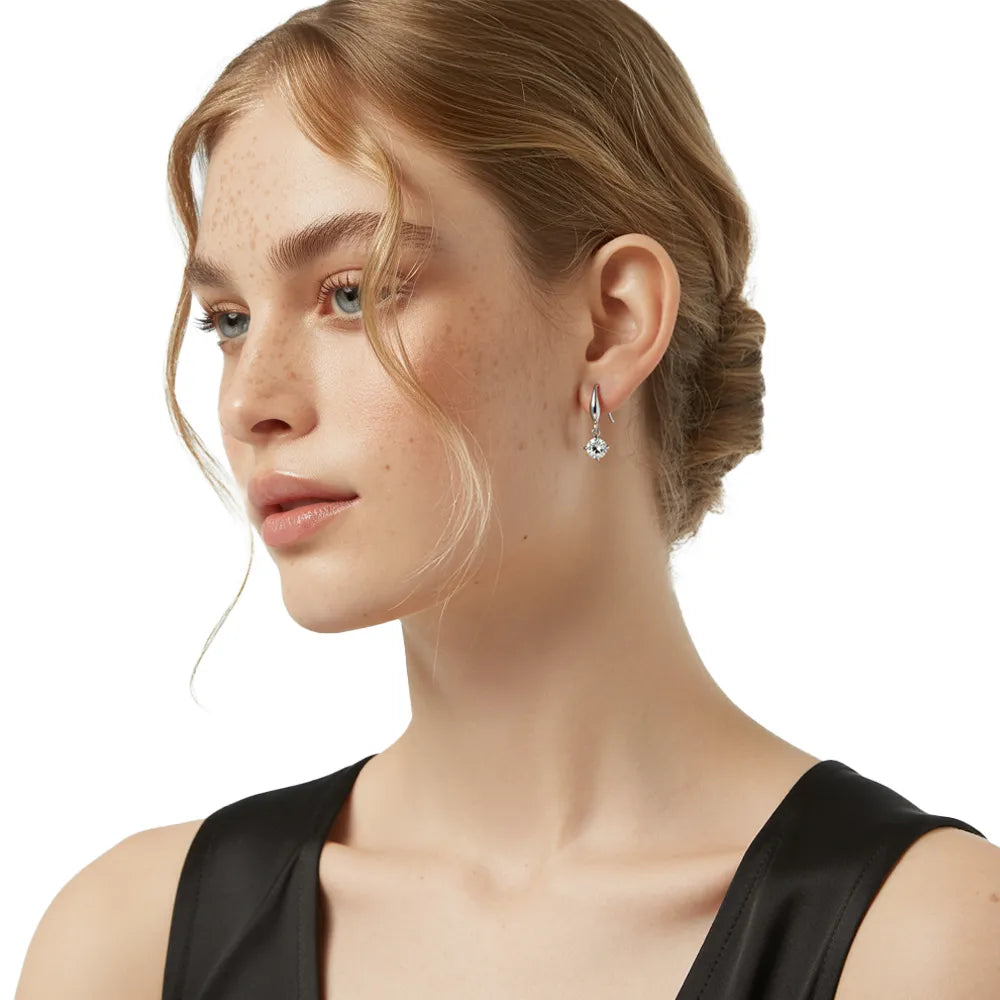 Model wearing the polished stainless steel Astra Solitaire Dangle Earrings.