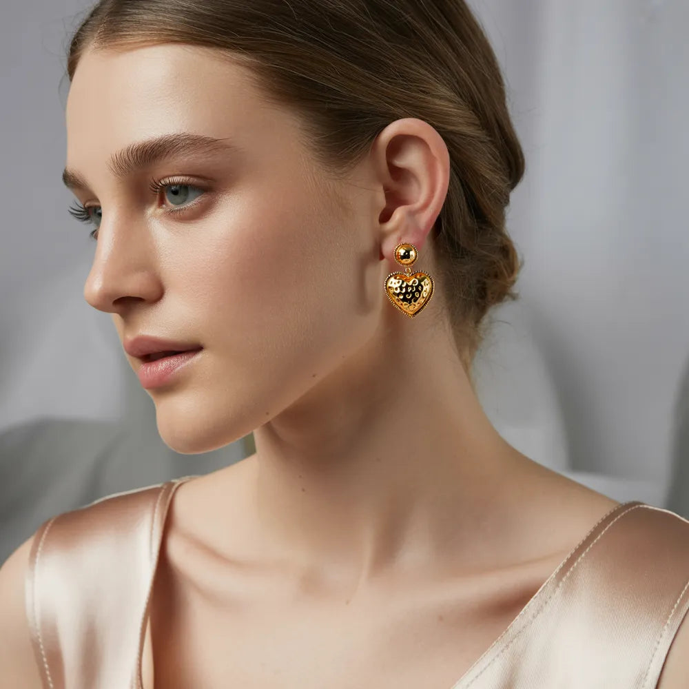 Model wearing the 18K gold Baroque Heart Drop Earrings.