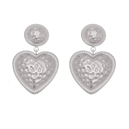Polished 316L stainless steel drop earrings with textured baroque heart charms.