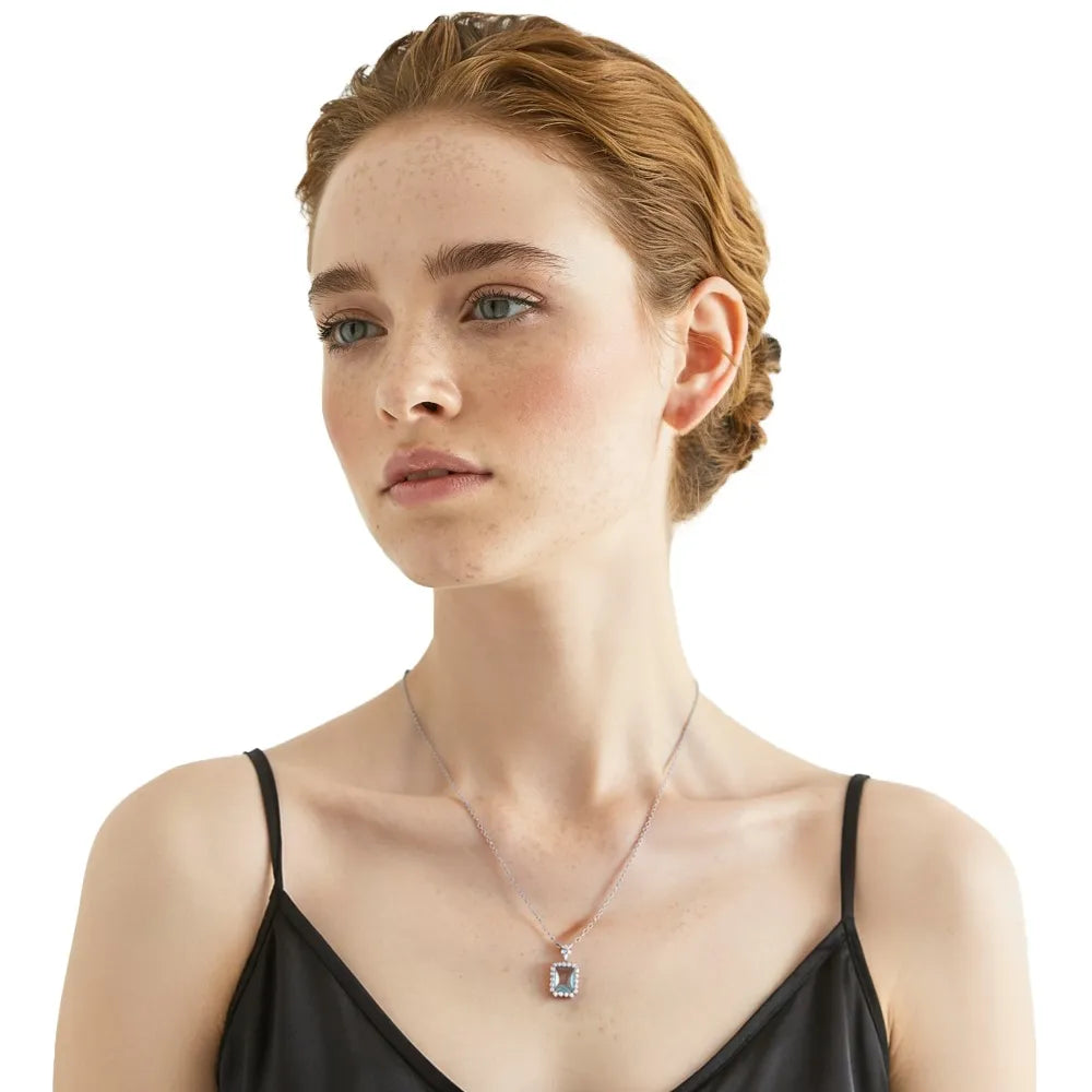 Redhead model wearing a silver aquamarine halo necklace with a black evening dress.