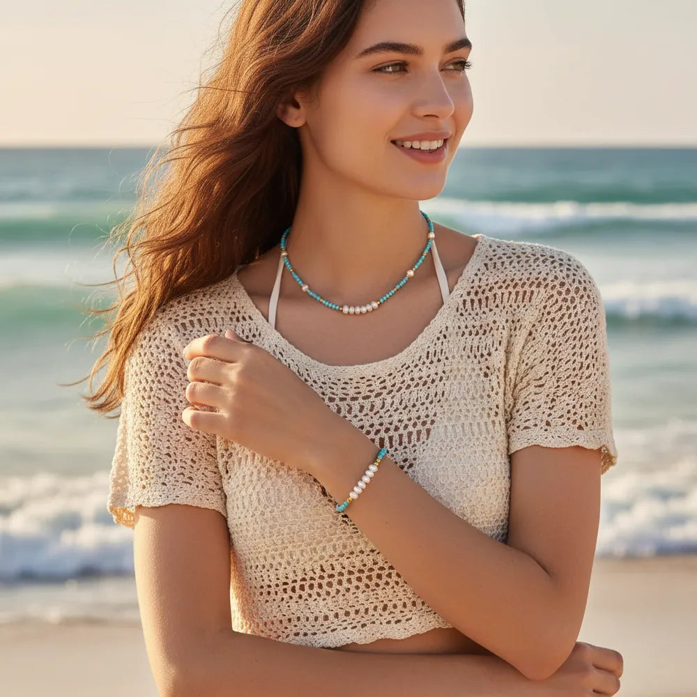 Model wearing the blue turquoise and pearl necklace set, showcasing a relaxed bohemian beach style perfect for vacation outfits.