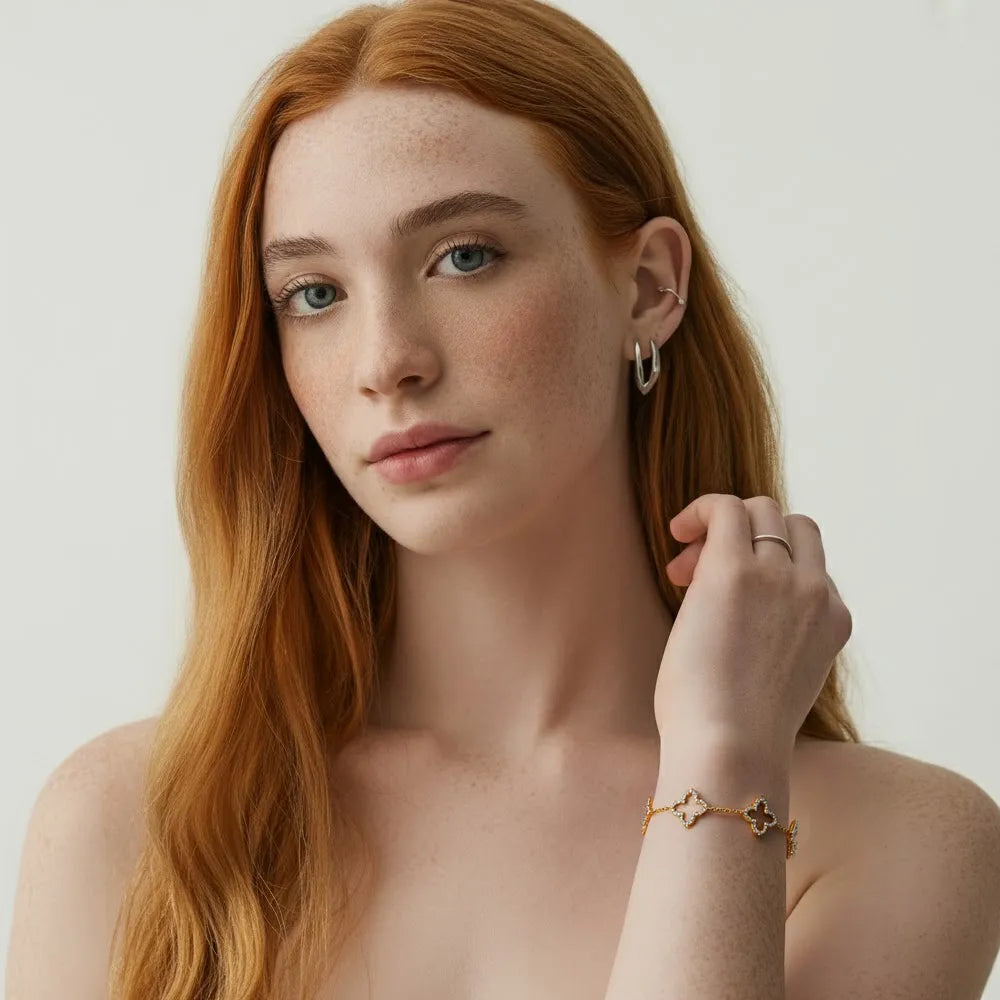 A model wearing the delicate 18k gold plated Fortuna Clover Bracelet, showcasing its elegant style