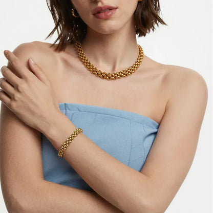 Model wearing the chunky gold toggle bracelet styled with a chic outfit, showcasing how the bold links elevate a daily look.